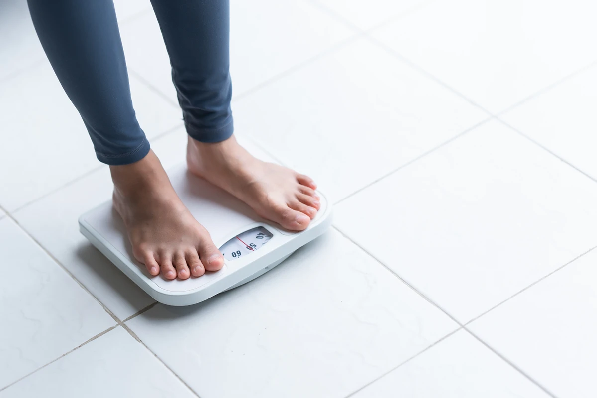 Person standing on a digital weight scale