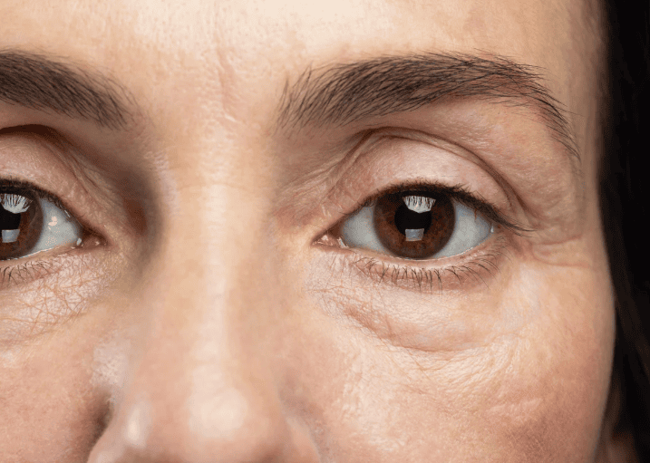 Close-up of a woman's eyes, showcasing their color and expression with a soft focus on the eyelashes.