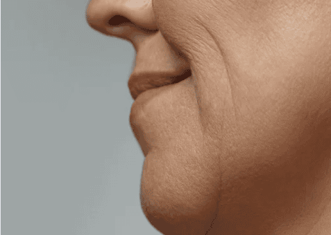 A woman with a small neck and a petite nose, showcasing her delicate facial features.